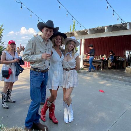 Sydney, Lisa, and Trent Sweeney are posing in a cowboy outfit.
